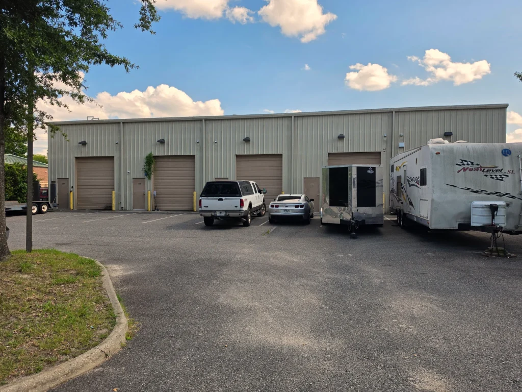 The rear of 2973 South Military Highway, roll-up door and entrance door to each suite